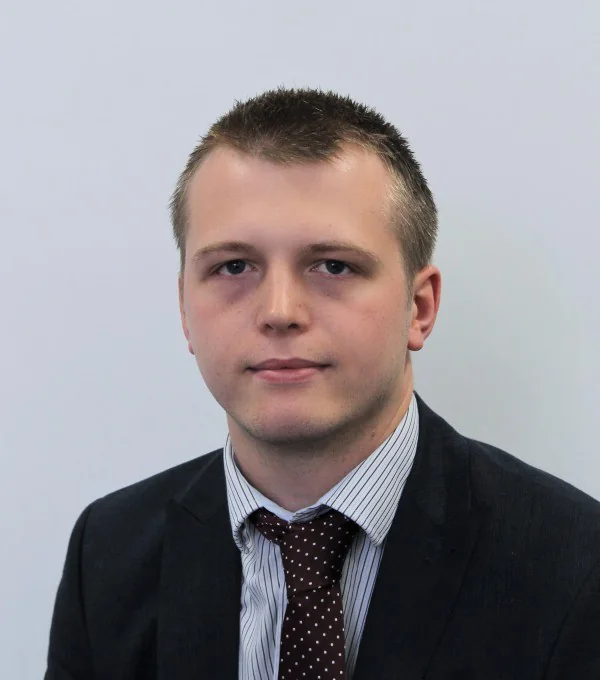 Steve Benton, head and shoulders, in a dark suit and tie